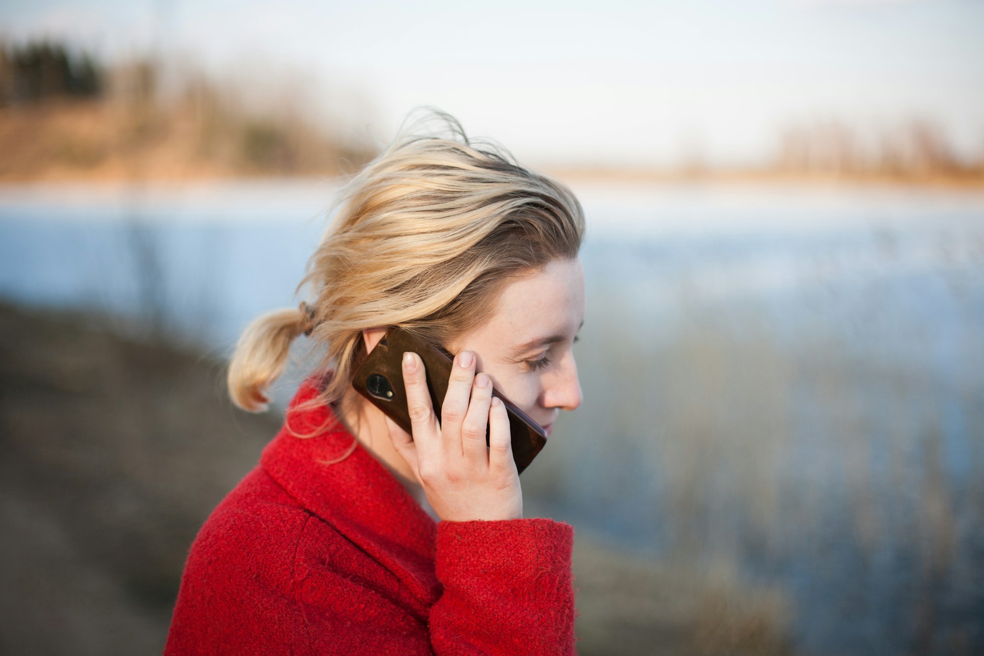 Woman calmly talking on the phone outdoors