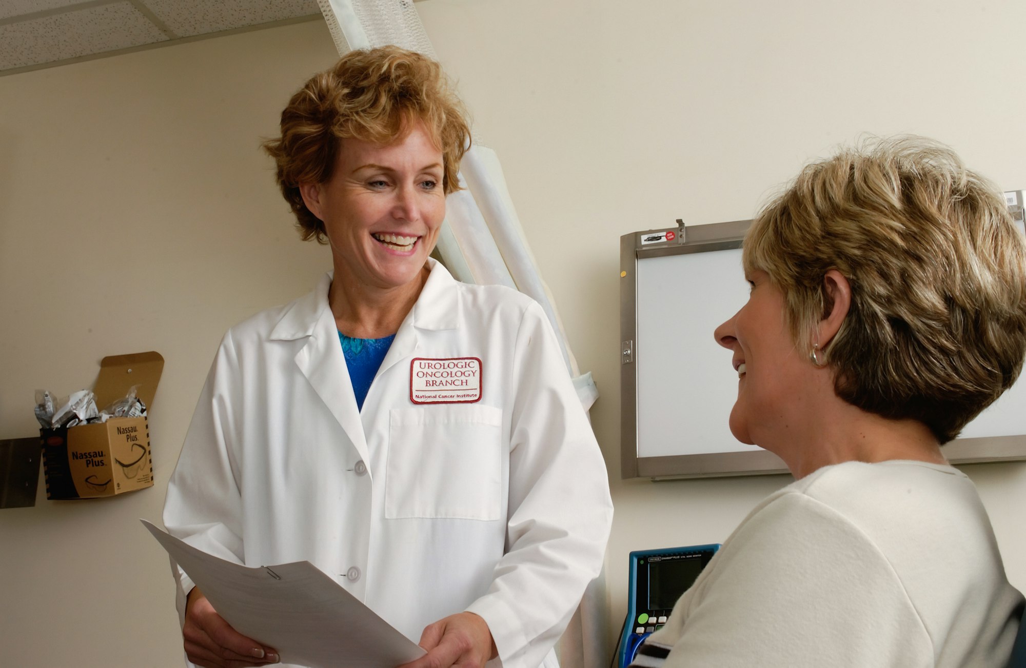 Smiling doctor speaking with a patient