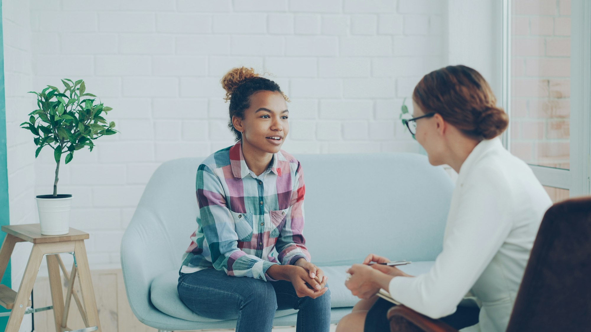 Counselor talking with a client in a bright office